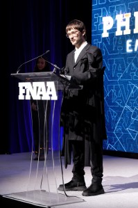 NEW YORK, NEW YORK - DECEMBER 04: Phileo Landowski speaks onstage during the Footwear News Achievement Awards (FNAAs) 2024 at Cipriani South Street on December 04, 2024 in New York City.  (Photo by Craig Barritt/Footwear News via Getty Images)