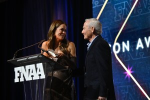 NEW YORK, NEW YORK - DECEMBER 04:  Brooke Burke and David Weinberg speak onstage during the Footwear News Achievement Awards (FNAAs) 2024 at Cipriani South Street on December 04, 2024 in New York City. (Photo by Roy Rochlin/Footwear News via Getty Images)