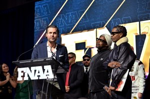 NEW YORK, NEW YORK - DECEMBER 04: Arne Freundt and A$AP Rocky speak onstage at the Footwear News Achievement Awards (FNAAs) 2024 at Cipriani South Street on December 04, 2024 in New York City. (Photo by Roy Rochlin/Footwear News via Getty Images)