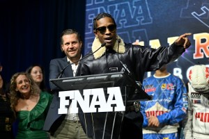 NEW YORK, NEW YORK - DECEMBER 04: Arne Freundt and A$AP Rocky speak onstage at the Footwear News Achievement Awards (FNAAs) 2024 at Cipriani South Street on December 04, 2024 in New York City. (Photo by Roy Rochlin/Footwear News via Getty Images)