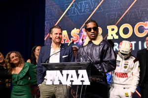 NEW YORK, NEW YORK - DECEMBER 04: Arne Freundt and A$AP Rocky speak onstage at the Footwear News Achievement Awards (FNAAs) 2024 at Cipriani South Street on December 04, 2024 in New York City. (Photo by Roy Rochlin/Footwear News via Getty Images)