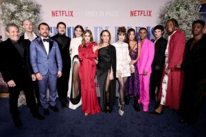 NEW YORK, NEW YORK - DECEMBER 15: (L-R) Darren Starr, Bruno Gouery, William Abadie, Lucas Bravo, Kate Walsh, Camille Razat, Philippine Leroy-Beaulieu, Lily Collins, Ashley Park, Lucien Laviscount, Paul Forman, JeremyO. Harris, and Samuel Arnold attend the Emily In Paris French Consulate Red Carpet at French Consulate on December 15, 2022 in New York City. (Photo by Jamie McCarthy/Getty Images for Netflix)