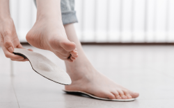 woman fitting an insole for heel pain