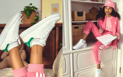 girl wearing white adidas sneakers in her bedroom